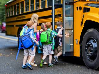 kids getting on the school bus
