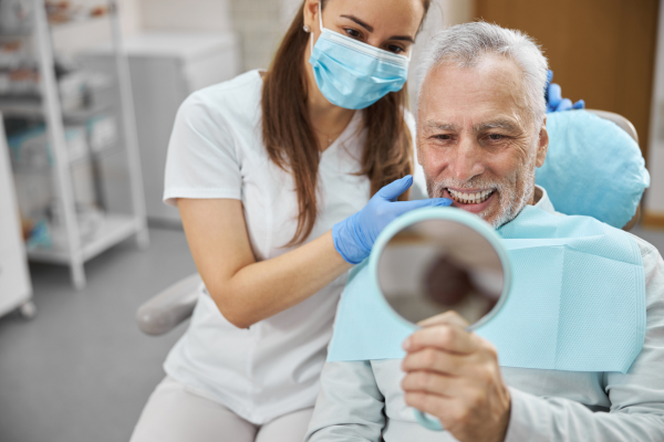 man looking at dental implants